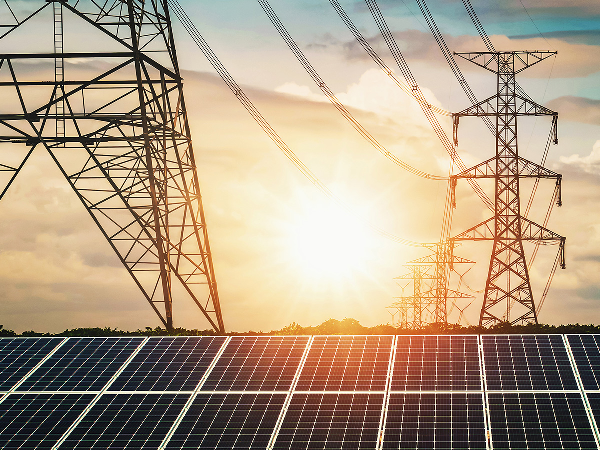 Image of a solar farm next to traditional powerlines