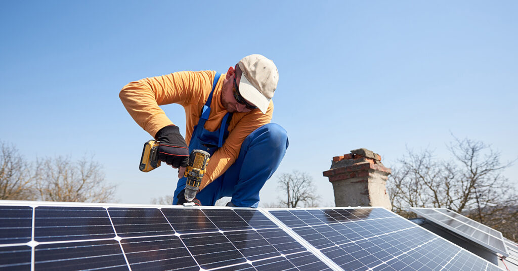 Image of a man installing a solar panel
