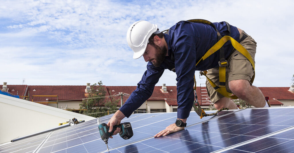image of a man installing a solar panel