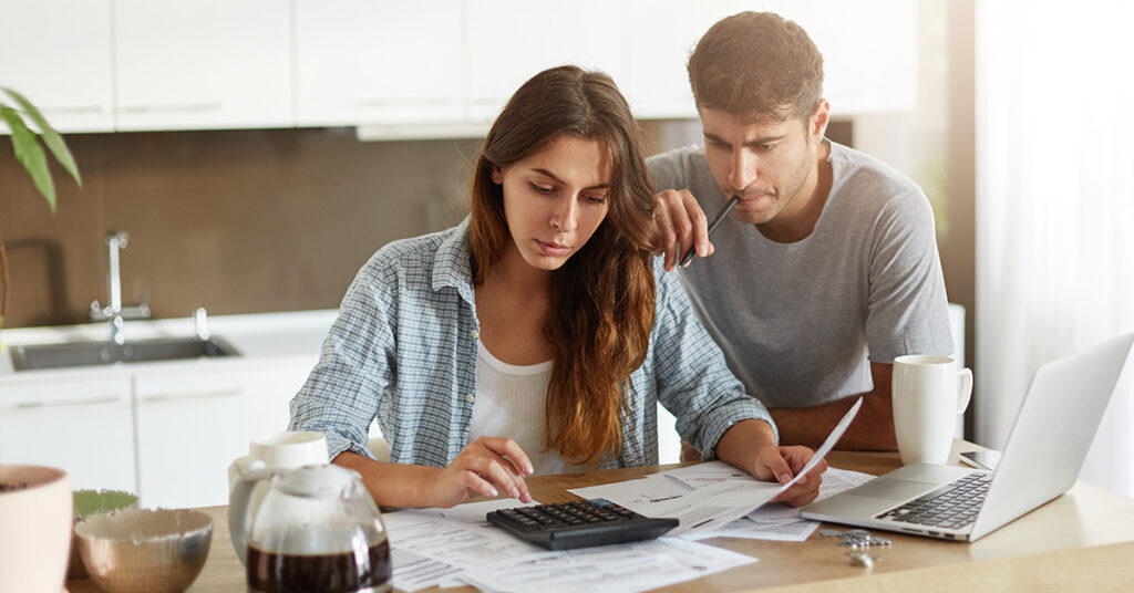 Image of a couple looking at a bill