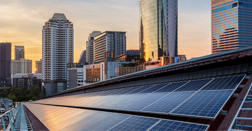 Image of a solar roof against a city