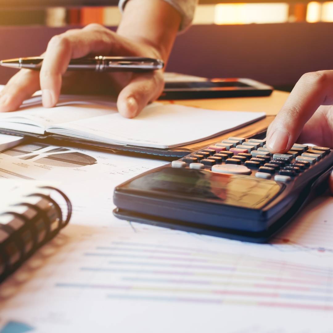 A person using a calculator to plan finances