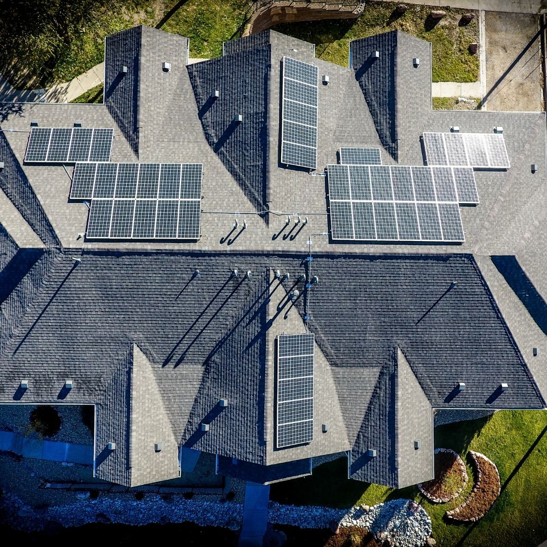 drone view of a home with solar panels