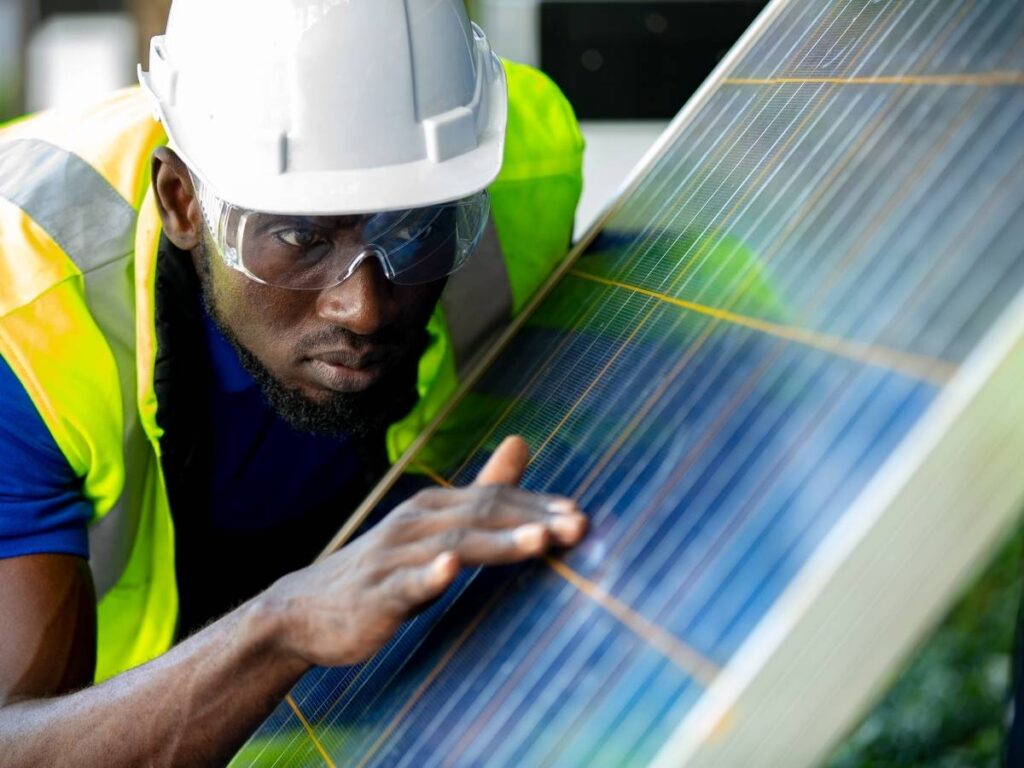 A man inspecting a solar panel