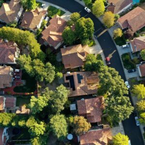 Aerial view of homes, one with solar panels