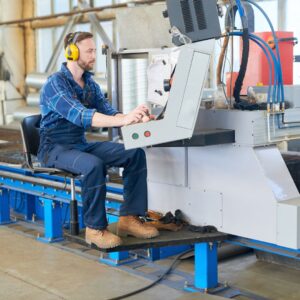 a worker in safety gear using machines at work