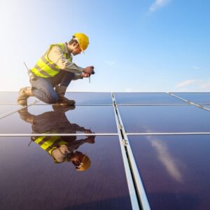 a man in safety gear taking a picture of a solar panel