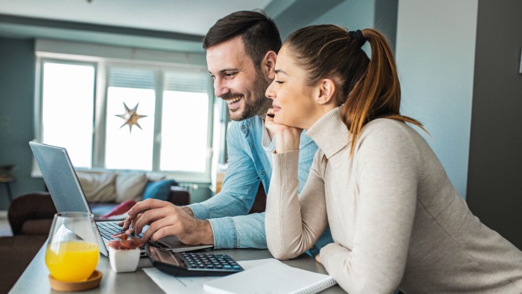 Couple looking at a laptop screen