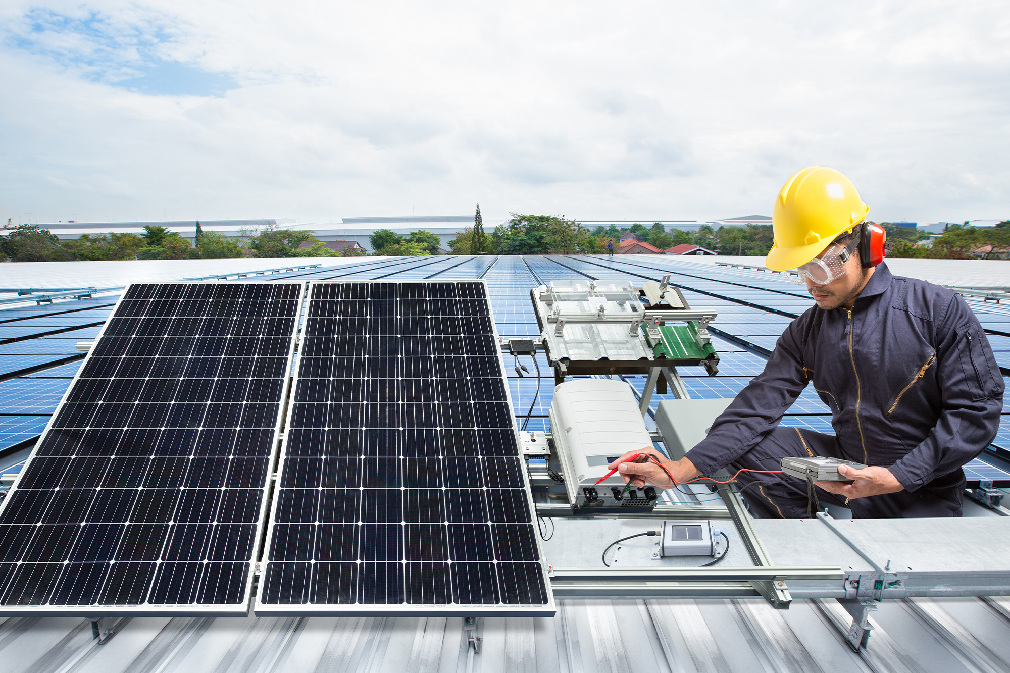 a professional in safety gear testing a solar battery