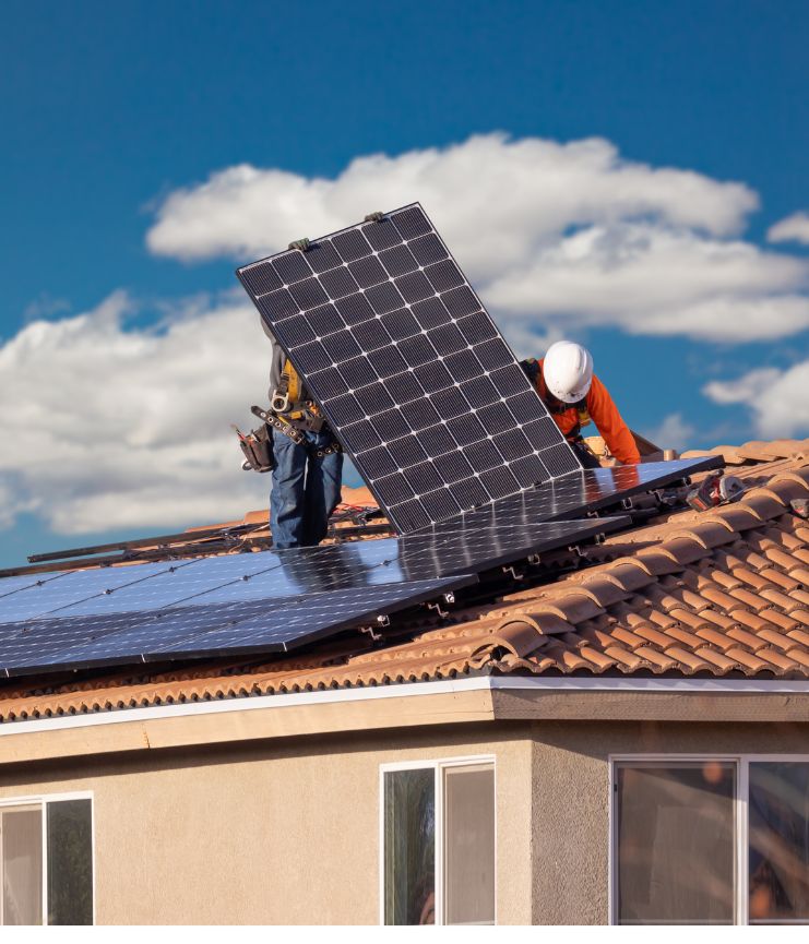 two workers placing panels