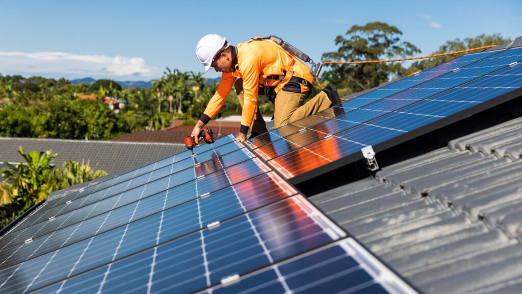 technician installing solar panel