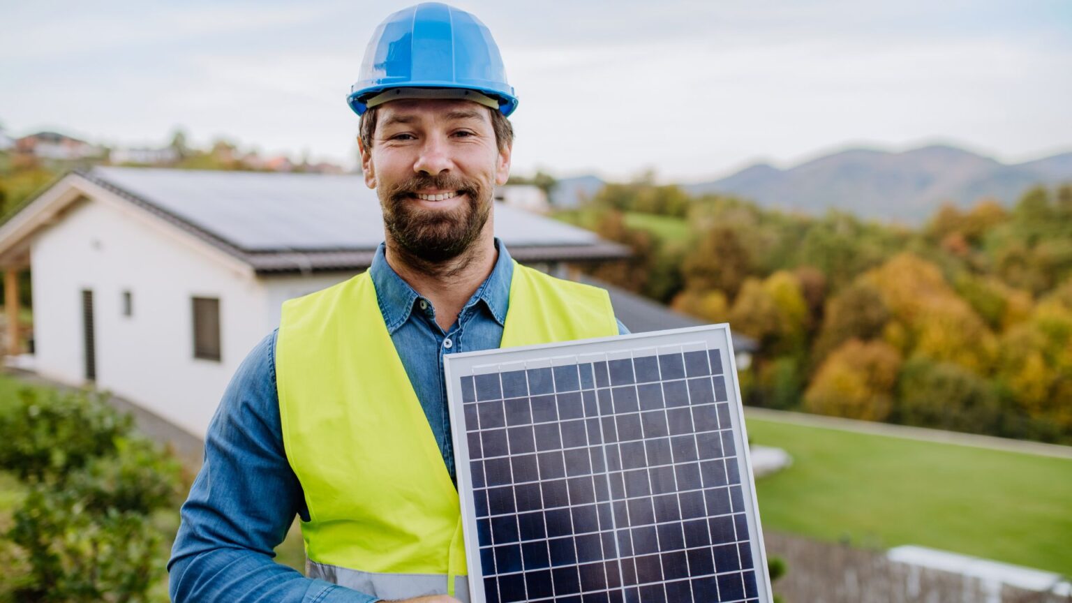 Person in hard hat wearing solar panel model