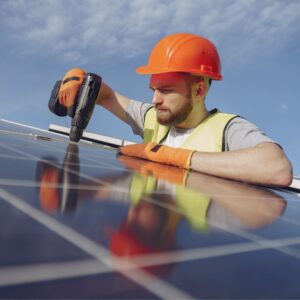 person repairing a solar panel