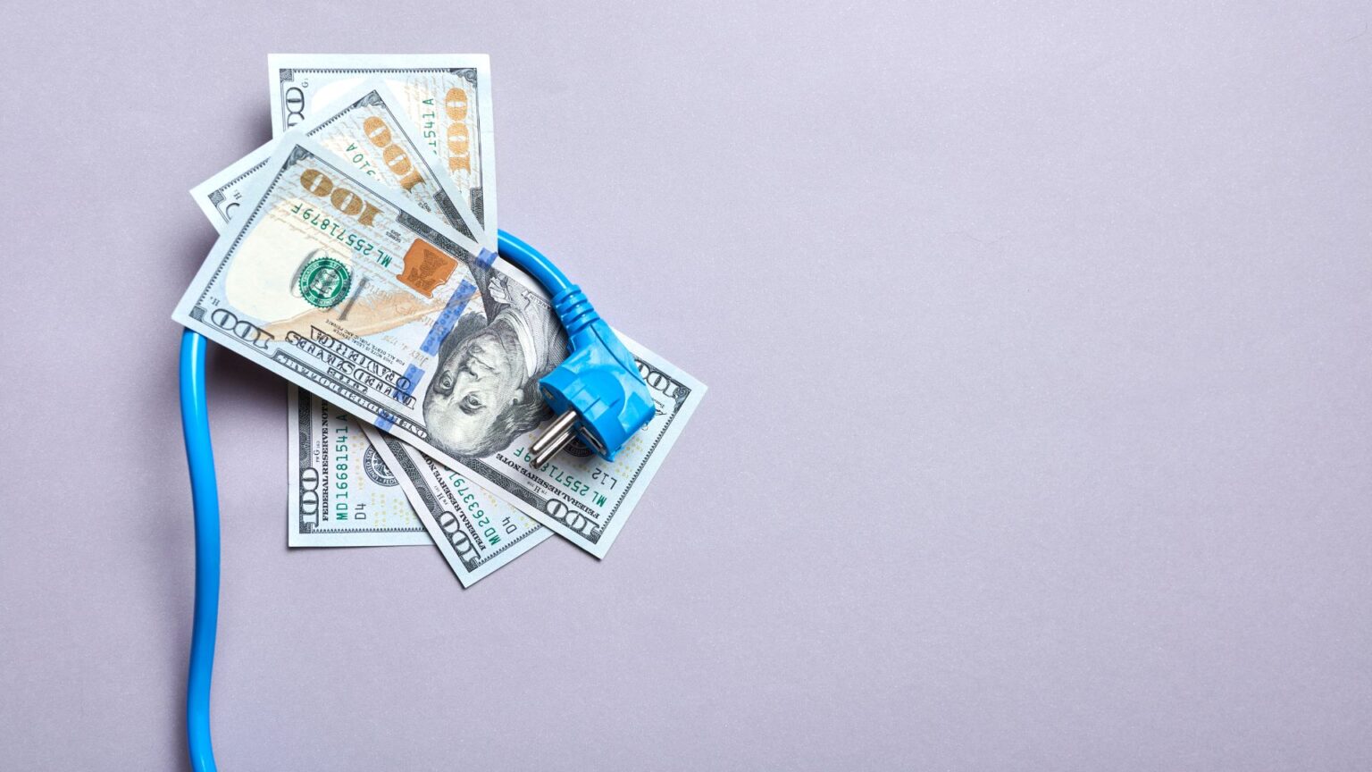 a power cord wrapped around hundreds of dollars