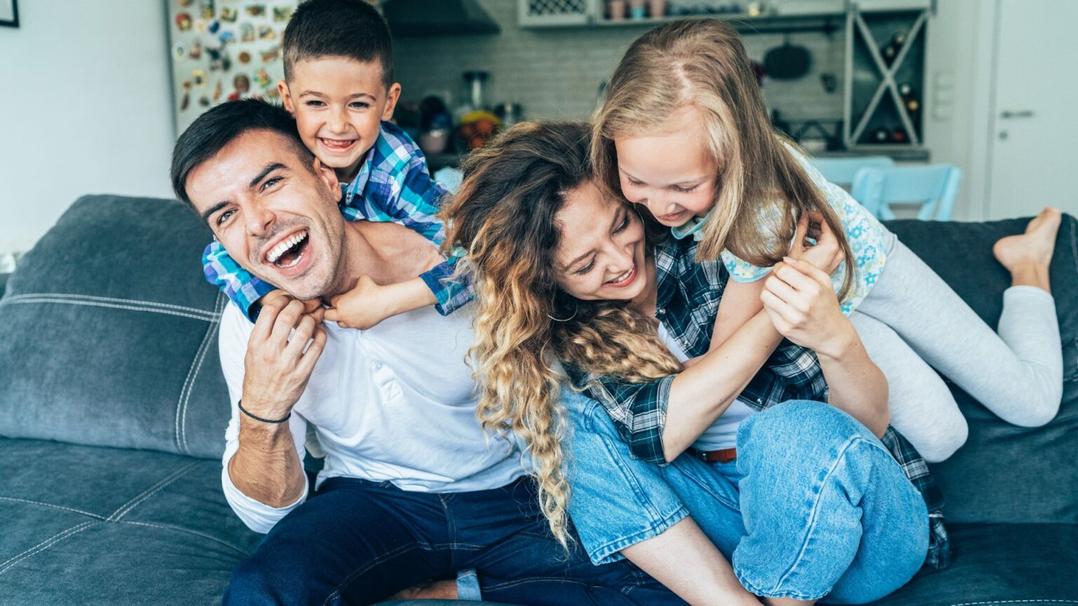 Happy family laughing on a couch