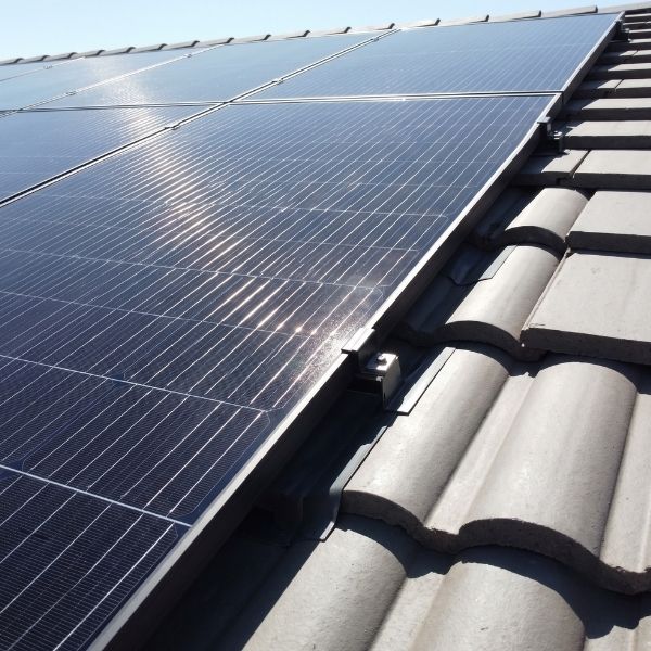 Close-up detail of high-efficiency solar panels mounted on a residential roof.