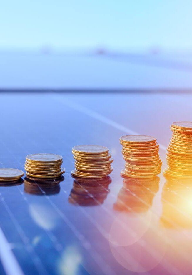 coins stacked on solar panel
