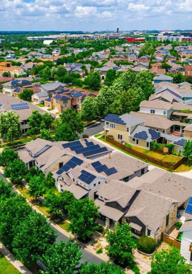 birds-eye view of neighborhood with solar panels on houses